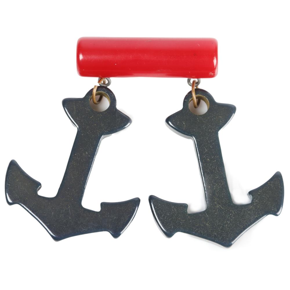 Appraisal: RED BAKELITE BAR WITH TWO ANCHOR CHARM DROPS H X