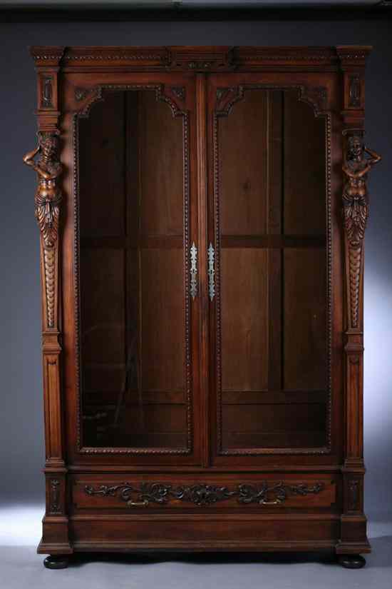 Appraisal: RENAISSANCE REVIVAL CARVED MAHOGANY VITRINE th century Molded cornice pair