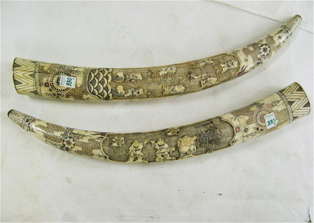 Appraisal: PAIR OF CARVED AND VENEERED BONE TUSKS Chinese th century