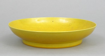 Appraisal: A Yellow Monochrome Dish Chinese Qing A thinly potted plate