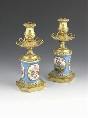 Appraisal: A pair of French ormolu and porcelain candlesticks painted panels