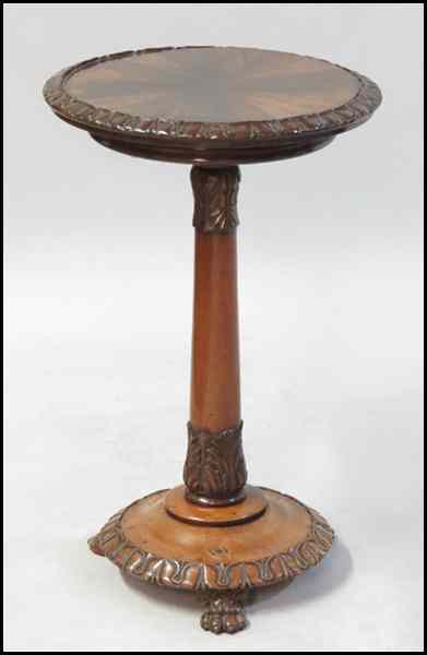 Appraisal: CONTINENTAL MIXED WOOD ROUND TABLE Raised on three paw feet