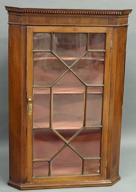 Appraisal: George III mahogany hanging corner cupboard with a mullioned door