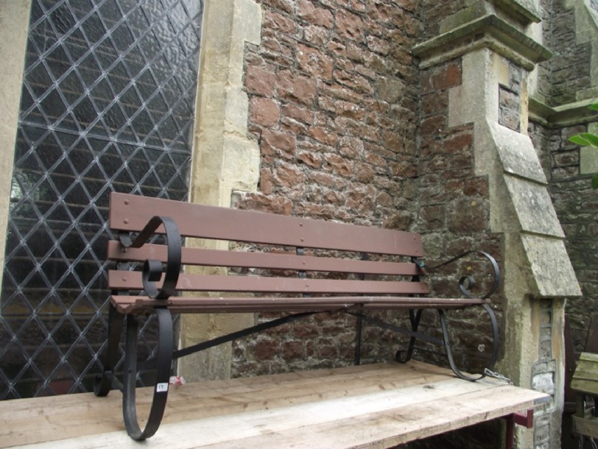 Appraisal: A sprung steel garden bench with wooden slatted seat and