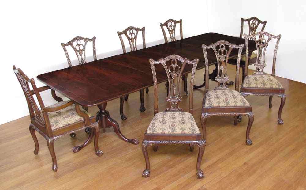 Appraisal: CHIPPENDALE STYLE MAHOGANY DINING TABLE AND CHAIRS Double pedestal base