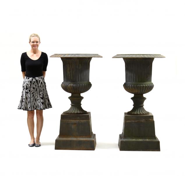 Appraisal: A MASSIVE PAIR OF CAST IRON URNS ON STANDS th