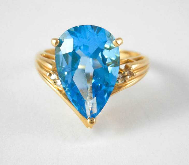 Appraisal: BLUE TOPAZ DIAMOND AND FOURTEEN KARAT GOLD RING with two