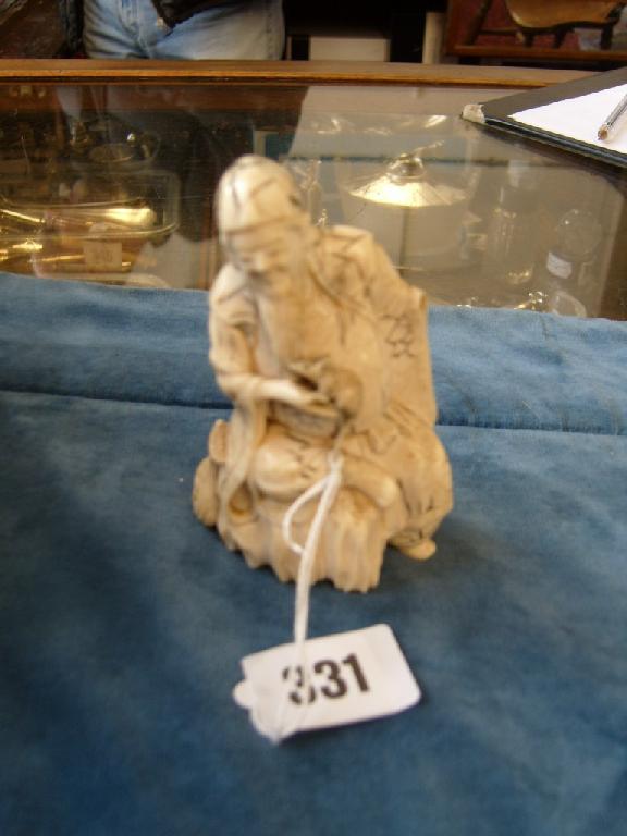 Appraisal: A th century Japanese carved ivory figure of a robed