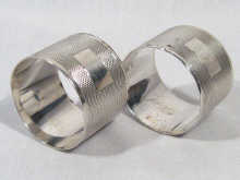 Appraisal: A pair of engine turned silver napkin rings hallmarked Sheffield