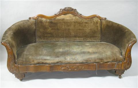 Appraisal: VICTORIAN VELVET UPHOLSTERED MAHOGANY SOFA the shaped crest with central