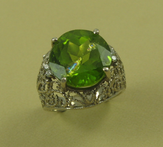 Appraisal: PERIDOT DIAMOND AND FOURTEEN KARAT GOLD RING The white gold