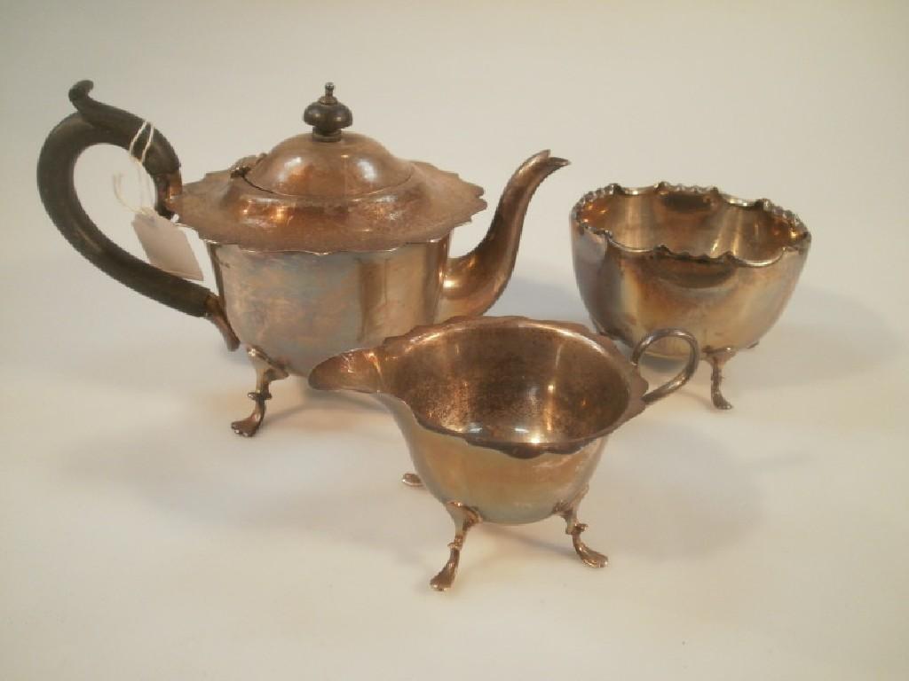 Appraisal: A silver tea pot and cream jug on pad feet