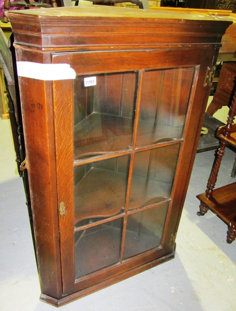 Appraisal: An oak glazed corner cupboard