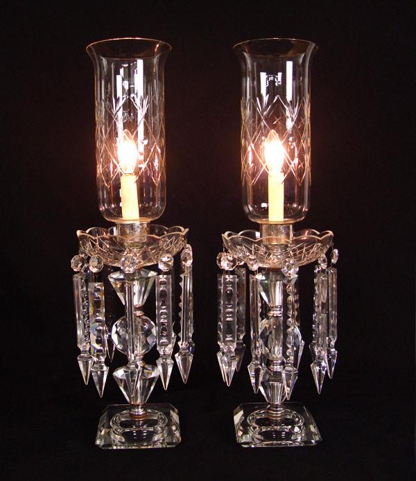 Appraisal: PAIR CRYSTAL HURRICANE TYPE LAMPS Etched glass hurricane shades long