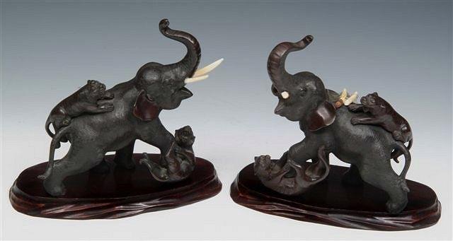 Appraisal: A PAIR OF JAPANESE BRONZE ELEPHANTS being attacked by tigers