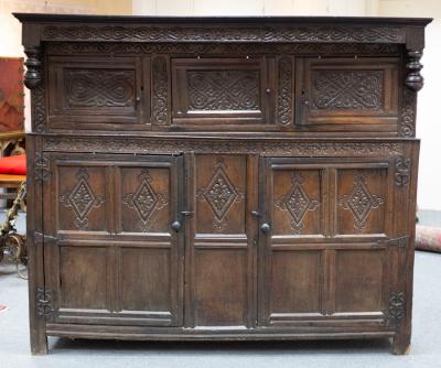 Appraisal: A very large Charles II Westmorland carved oak court cupboard