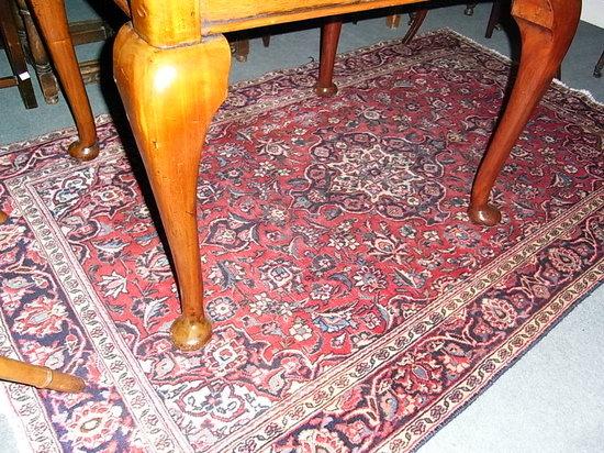 Appraisal: A RED GROUND RUG with central medallion and all over