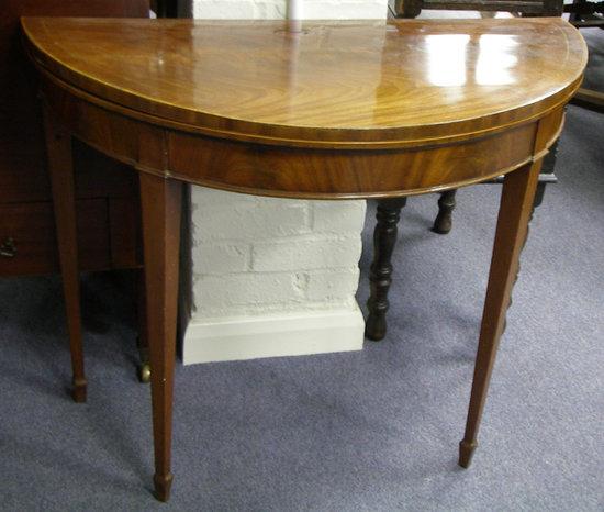 Appraisal: A Regency mahogany D shaped card table the top crossbanded