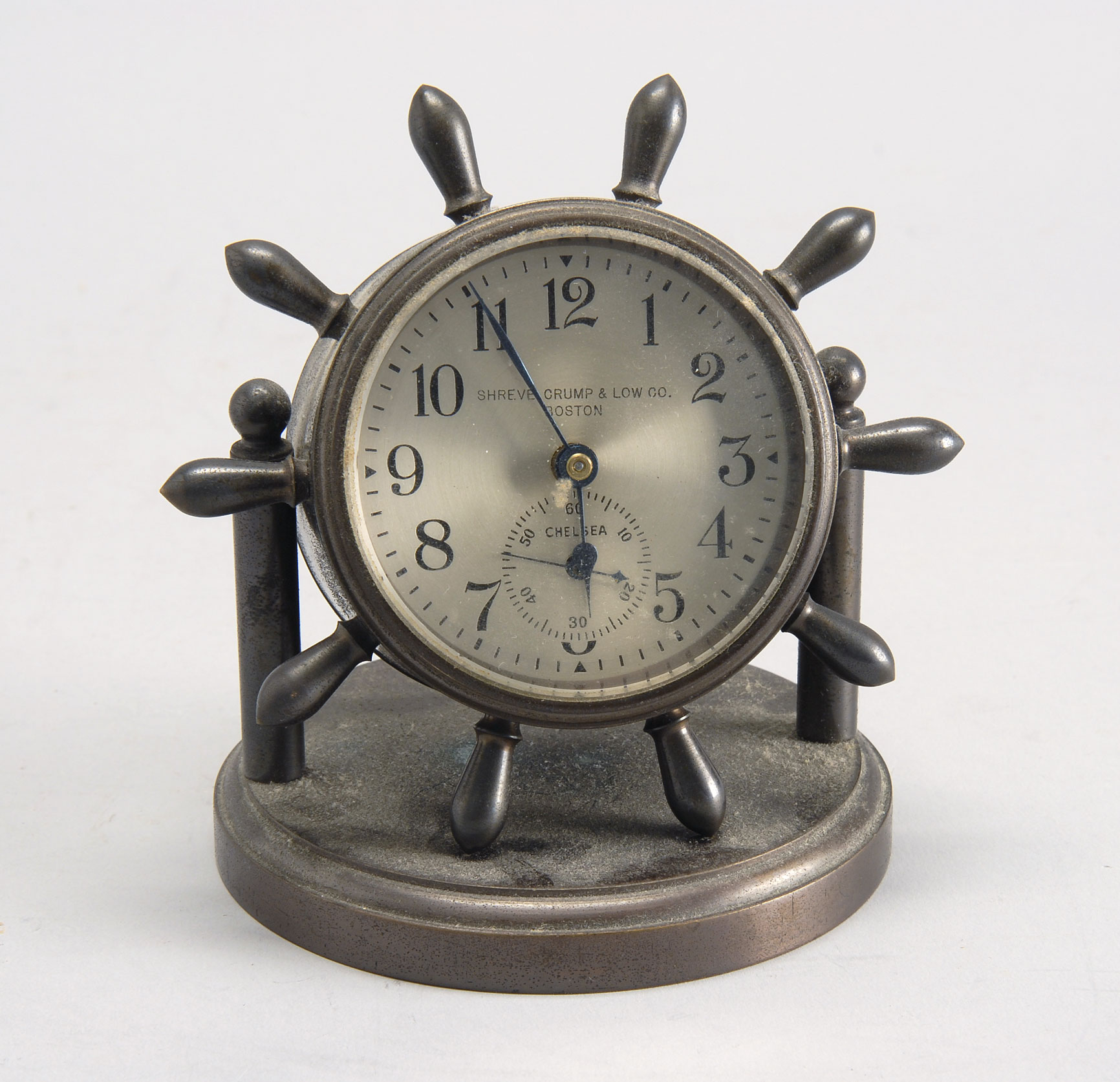 Appraisal: SMALL CHELSEA DESK CLOCK in ship's wheel form Retailed by