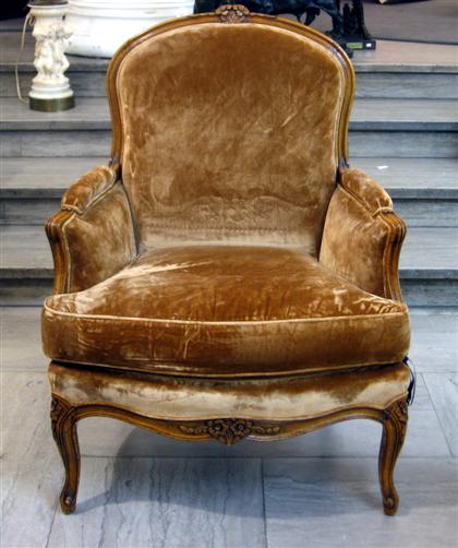 Appraisal: French beechwood fauteuil The shaped toprail centered by a carved