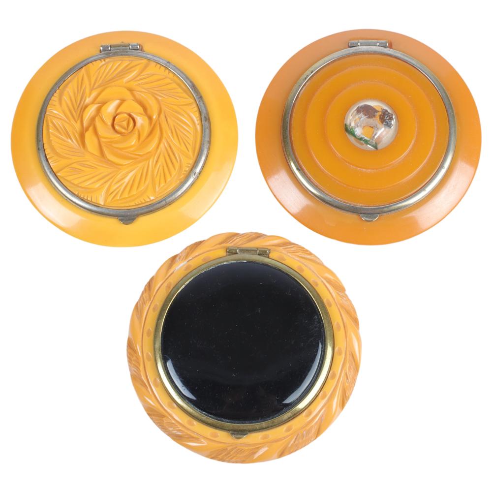 Appraisal: THREE BAKELITE CARVED BUTTERSCOTCH COMPACTS REVERSE CARVED AND PAINTED BULL