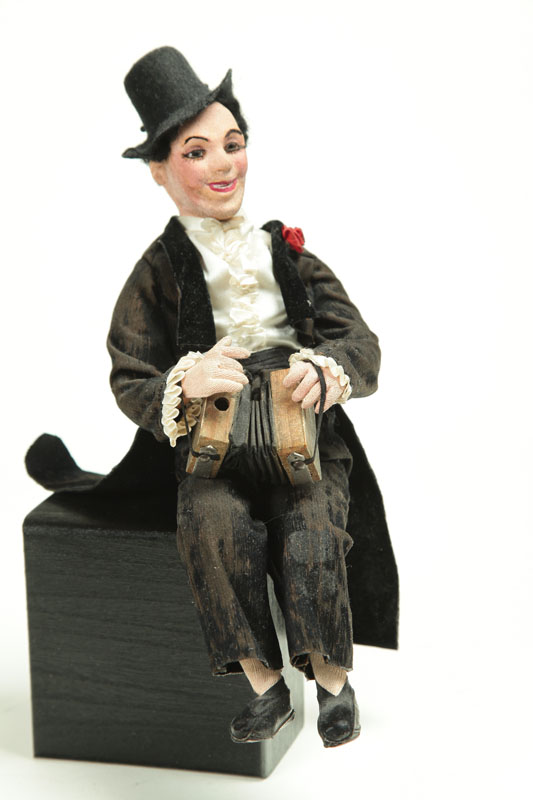 Appraisal: DOLL Germany - various fabrics Seated accordion player wearing a