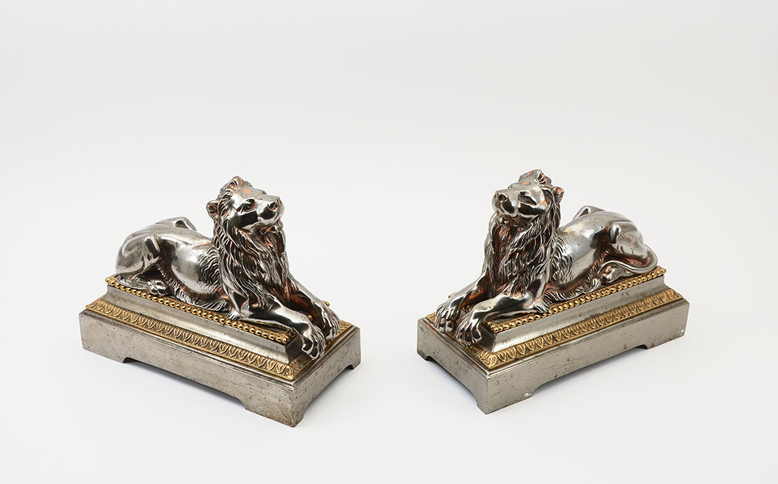 Appraisal: PAIR OF SILVERED FIGURAL LION BOOKENDS Pair of heavy cast