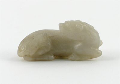 Appraisal: A Chinese pale celadon jade carving of a recumbent kylin