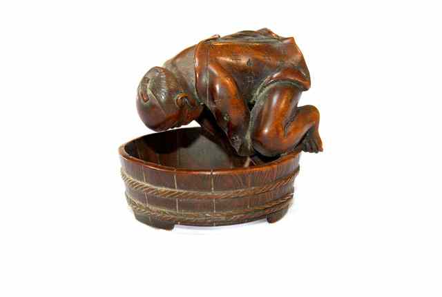 Appraisal: A JAPANESE CARVED BOXWOOD OKIMONO in the form of a