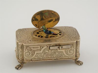 Appraisal: A rare Victorian silvergilt engraved singing bird box on paw