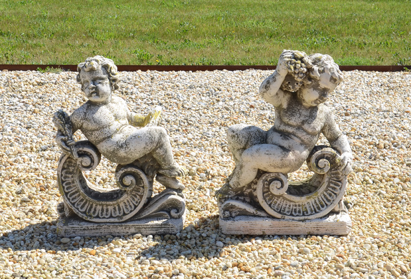 Appraisal: PAIR OF ROCOCO STYLE COMPOSITION GARDEN ORNAMENTS Each with a