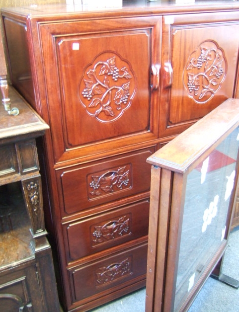 Appraisal: A th century Chinese hardwood side cabinet with a pair