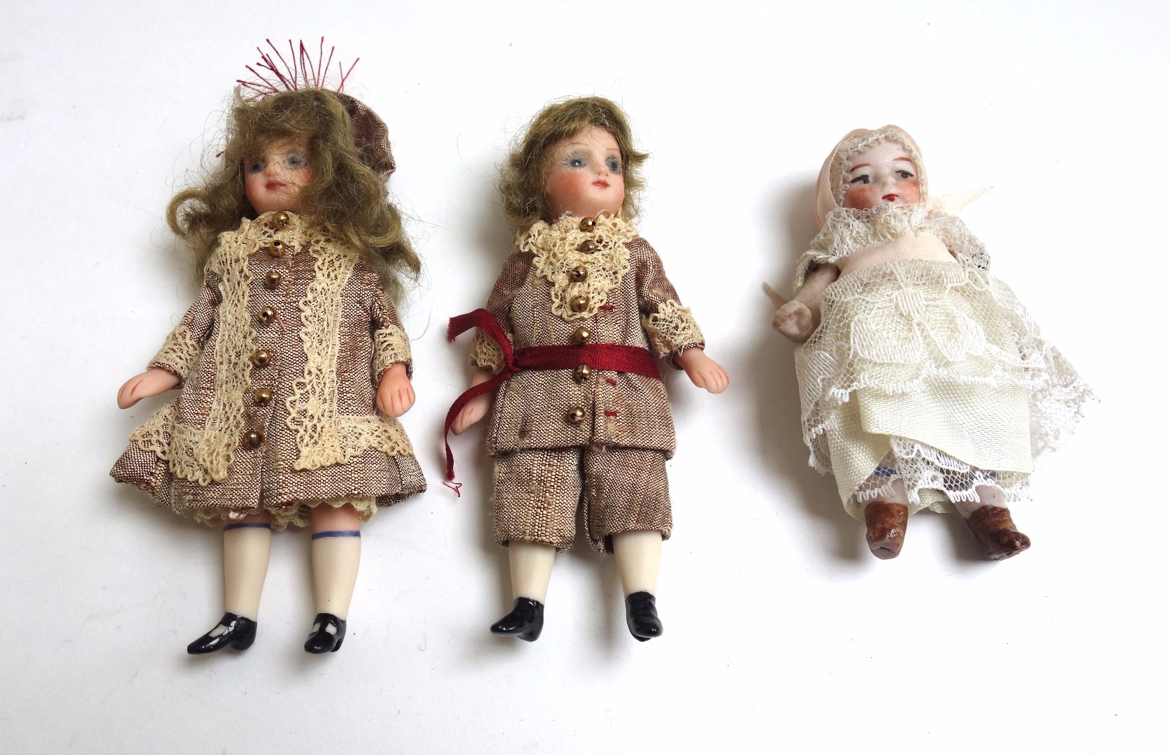 Appraisal: Three Continental miniature bisque head dolls early th century in