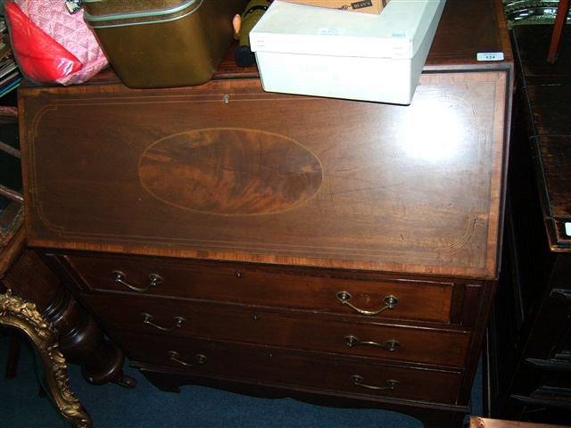 Appraisal: An Edwardian mahogany bureau with walnut crossbanding to the fall