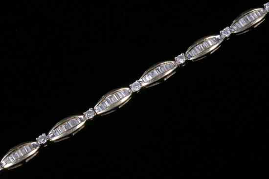 Appraisal: K YELLOW GOLD AND DIAMOND FLEXIBLE LINK BRACELET Twelve narrow