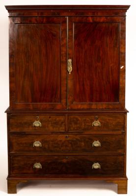 Appraisal: A Regency mahogany linen press fitted sliding trays enclosed by