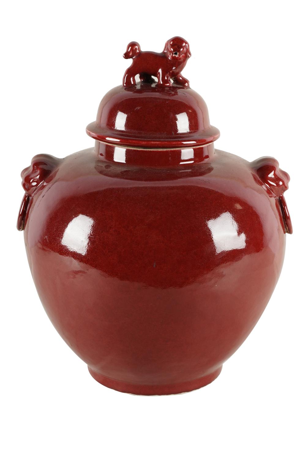 Appraisal: CHINESE OXBLOOD-GLAZED CERAMIC COVERED JARunsigned with foo dog finial inches