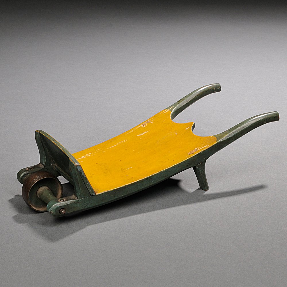 Appraisal: Miniature Green- and Yellow-painted Wheelbarrow America th century with incised