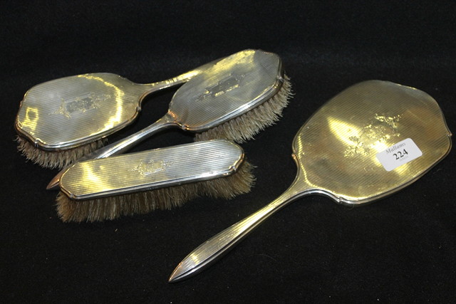 Appraisal: TWO SILVER BACKED BRUSHES and a mirror with engine turned