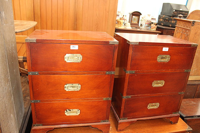 Appraisal: A PAIR OF REPRODUCTION MAHOGANY CAMPAIGN STYLE BEDSIDE CHESTS each