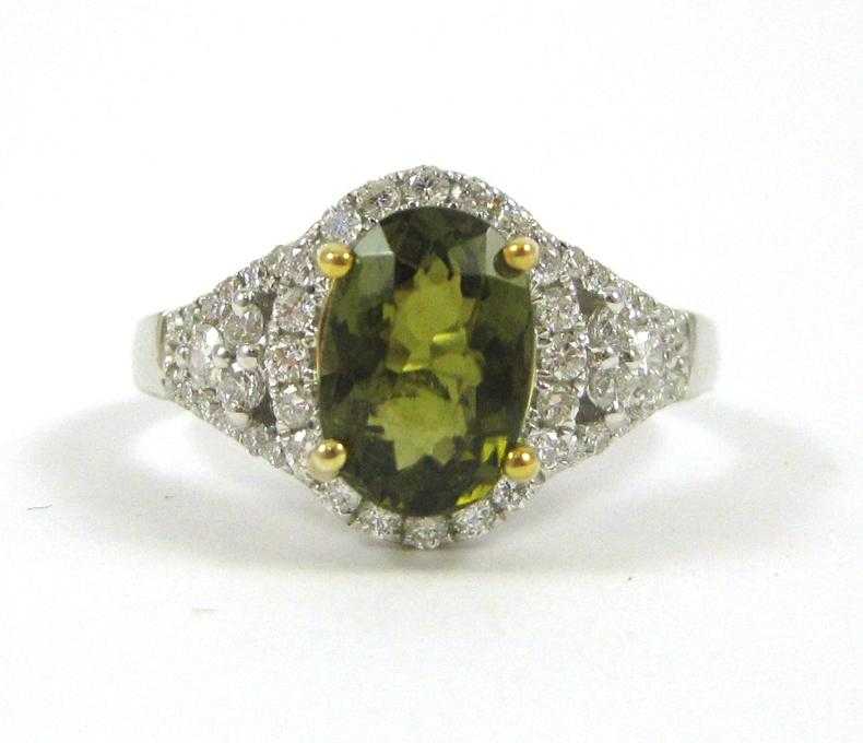 Appraisal: GREEN SAPPHIRE AND FOURTEEN KARAT GOLD RING The white and