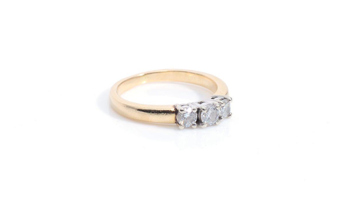 Appraisal: THREE STONE DIAMOND WEDDING BAND K yellow gold ring contains