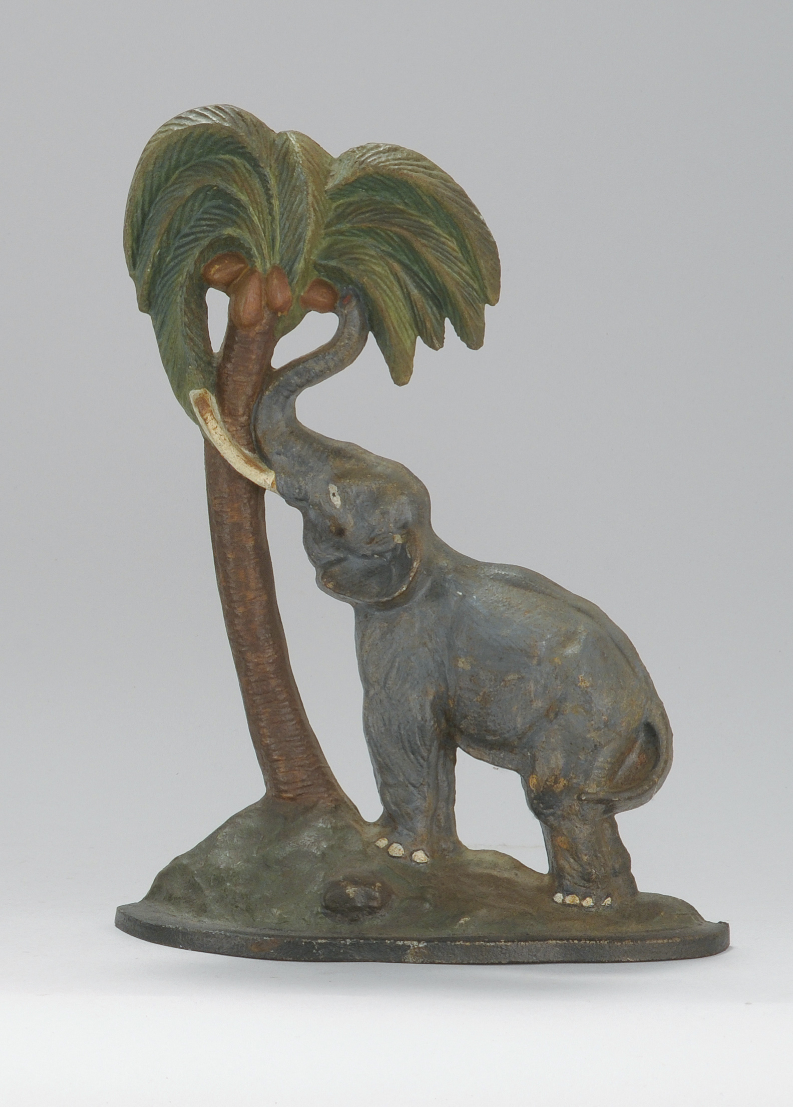 Appraisal: CAST IRON ELEPHANT AND PALM TREE DOOR STOP Early th