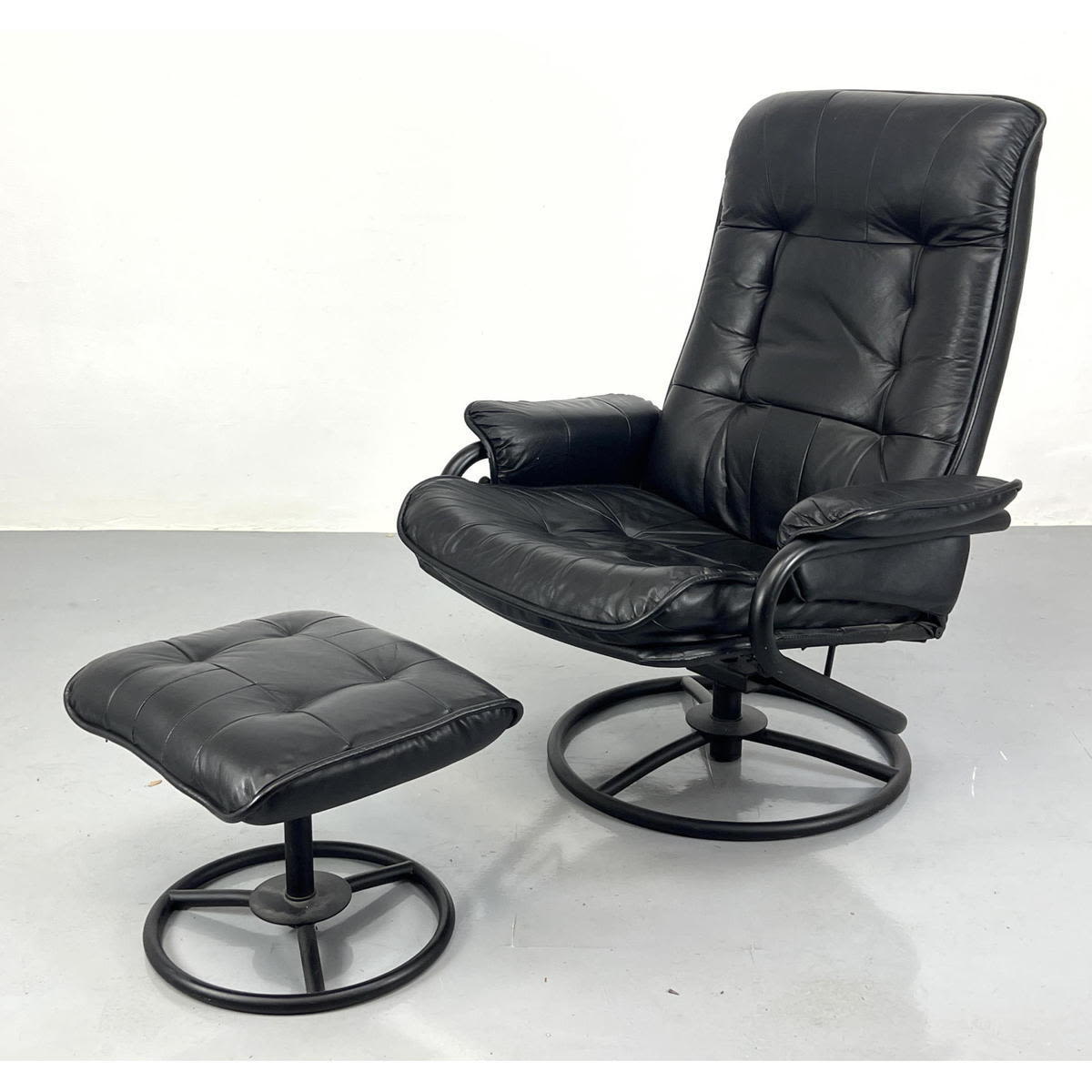 Appraisal: Pr Black Tube Frame Lounge Chair and Ottoman Round Steering