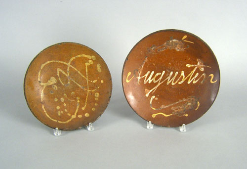 Appraisal: Two slip decorated redware chargers th c one inscribed Augustin