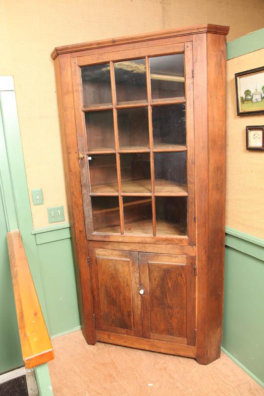 Appraisal: CORNER CUPBOARD Walnut with a twelve pane glazed door over