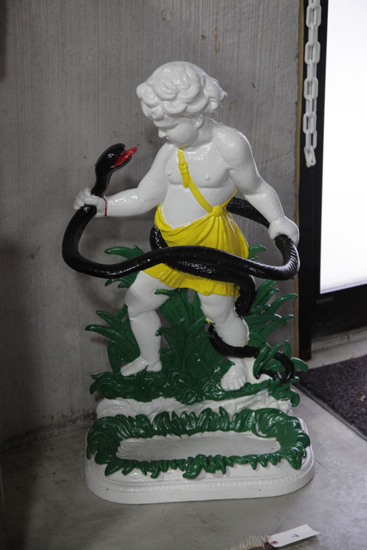 Appraisal: UMBRELLA STAND Painted cast iron stand depicting a boy holding