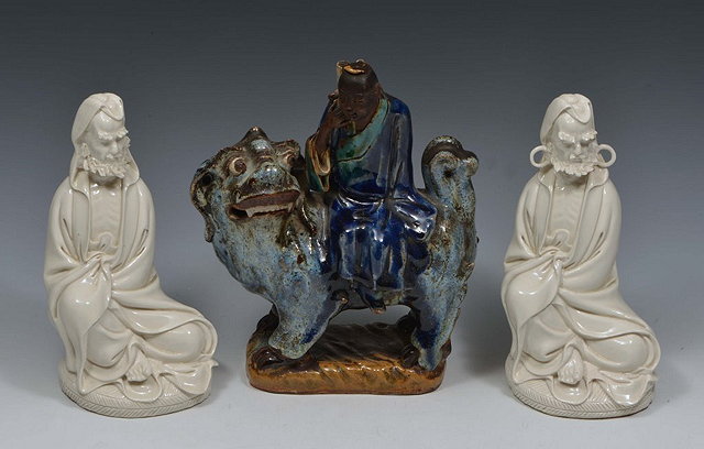 Appraisal: A CHINESE GLAZED TERRACOTTA MODEL OF A SCHOLAR seated on