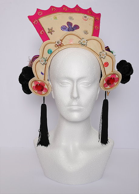 Appraisal: A pink cream and faux jewel head gear designed by