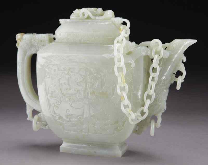 Appraisal: Chinese carved white jade teapot the lid attachedto the body